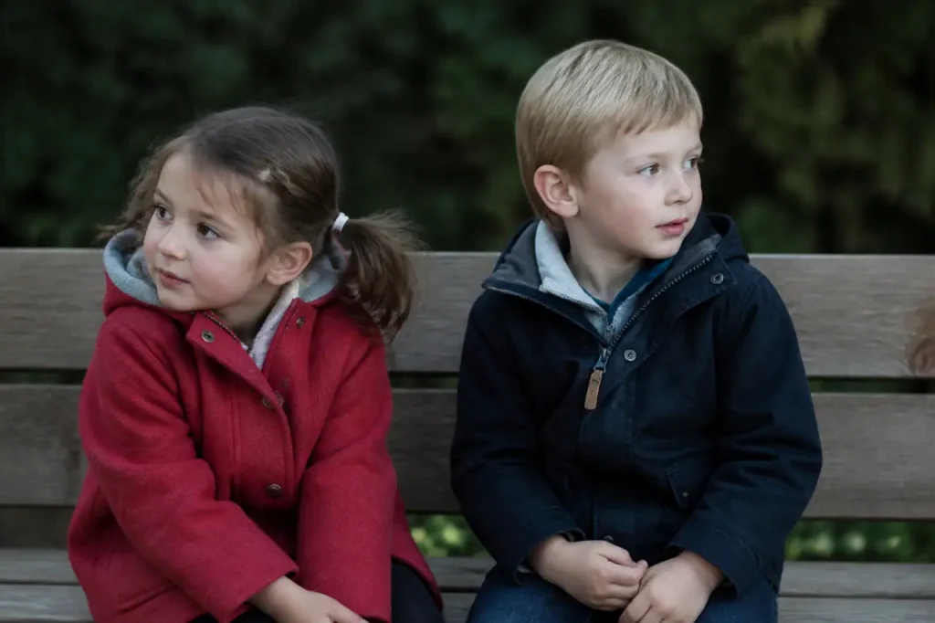 Jeunes enfants assis sur des bancs en bois